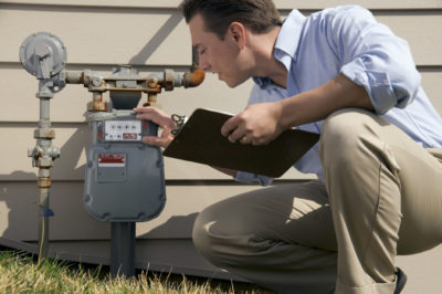 photo of a man checking the water meter